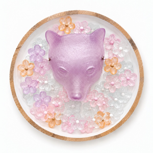 Bearin’ Wishes wall sculpture featuring a lavender glass bear head surrounded by pastel glass flowers in a circular wood frame.
