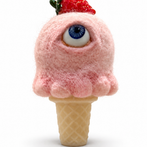 Pink needle-felted wool ice cream sculpture with a single blue eye, a glass strawberry on top, and a yellow cast glass cone.
