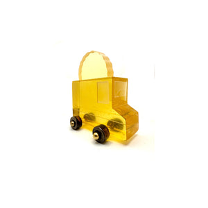 If You Build It They Will Come yellow cast glass taco truck sculpture with dark wheels and a taco-shaped sign on top, on a white background.
