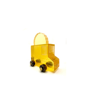 If You Build It They Will Come yellow cast glass taco truck sculpture with dark wheels and a taco-shaped sign on top, on a white background.
