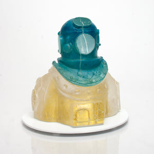 Personal Residence cast glass sculpture featuring a blue diver with a sandcastle inside its chest and 23k gold leaf details.
