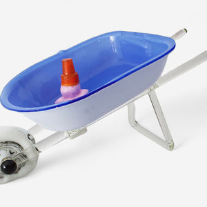 Reckless Driving glass sculpture of a blue-and-white wheelbarrow carrying an upside-down ice cream cone in a puddle of pink ice cream.
