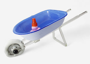 Reckless Driving glass sculpture of a blue-and-white wheelbarrow carrying an upside-down ice cream cone in a puddle of pink ice cream.
