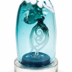Stillwater glass sculpture featuring an octopus with curling tentacles enclosed within a blue glass dome on a clear circular base.
